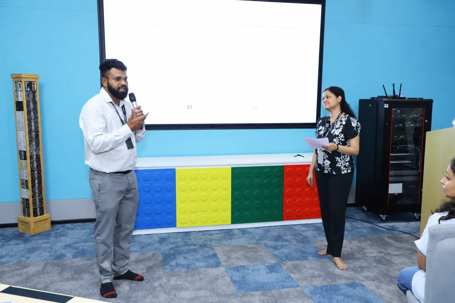 A facilitator and a participant talking a scenario through in front of the room